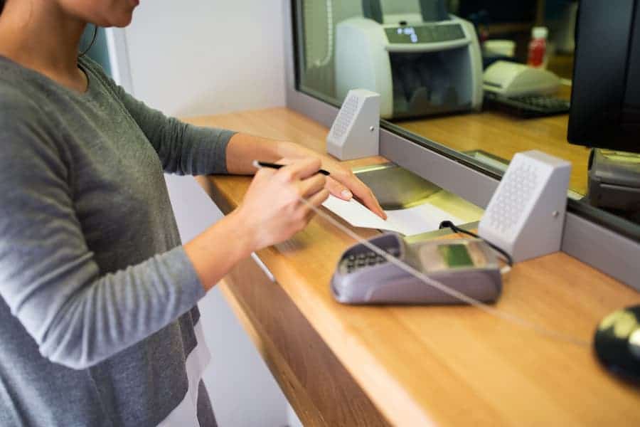 Bank Teller Working with Customer