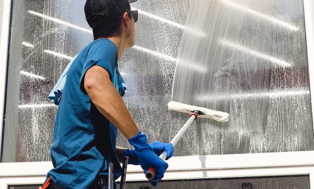 Commercial Cleaner Working on Cleaning Window