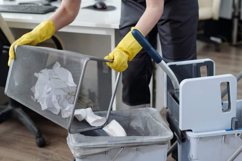 Man Emptying Trash and Cleaning