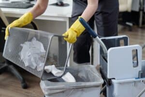 Man Emptying Trash and Cleaning