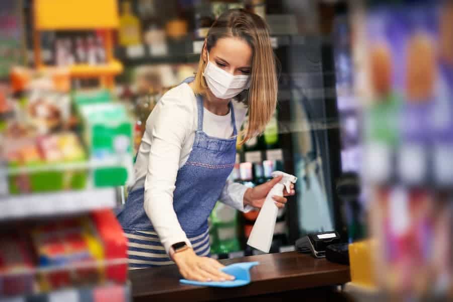 Woman Cleaning Store Counter