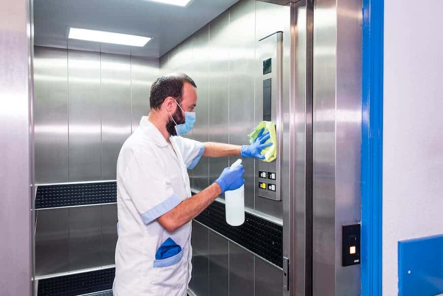 Worker Cleaning Elevator