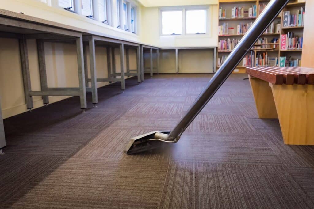 Worker Steam Cleaning School Carpet