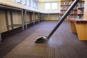 Worker Steam Cleaning School Carpet