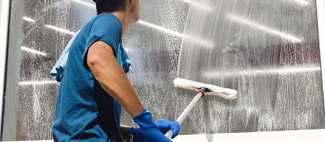 Commercial Cleaner Working on Cleaning Window