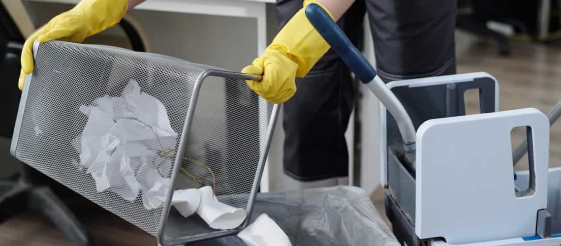 Man Emptying Trash and Cleaning