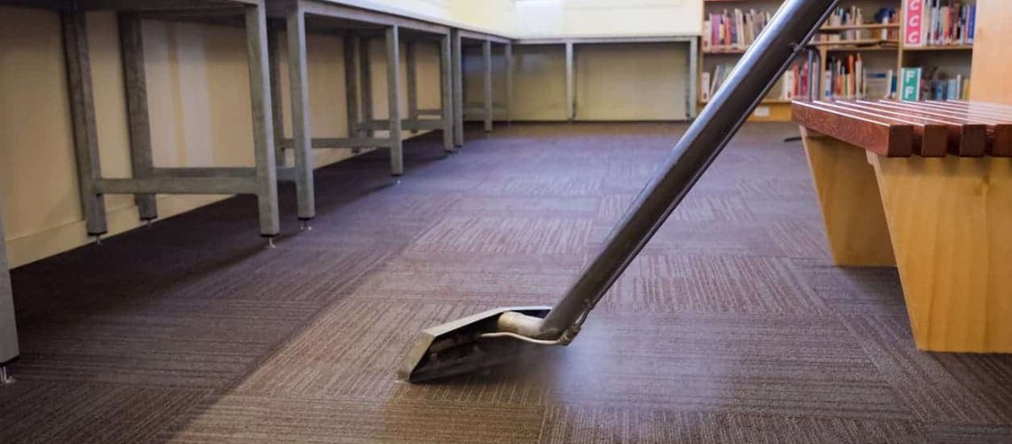 Worker Steam Cleaning School Carpet